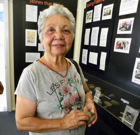 Photo : Aunty Matilda House viewing the stone artefact display 'Stones that Speak’