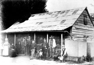 Ginninderra Store and Post Office. https://heritage.hall.act.au/display/1939/person/1954/george-harcourt.html[George Harcourt] with the paper under his arm.