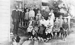 Teacher and pupils at https://heritage.hall.act.au/school/1245/mugwill-school.html[Mugwill Public School], c. 1917